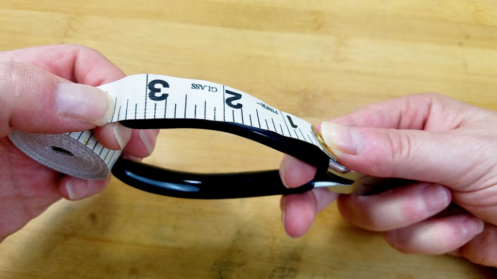 An image showing the author measuring the grips of her stepped bail-making pliers