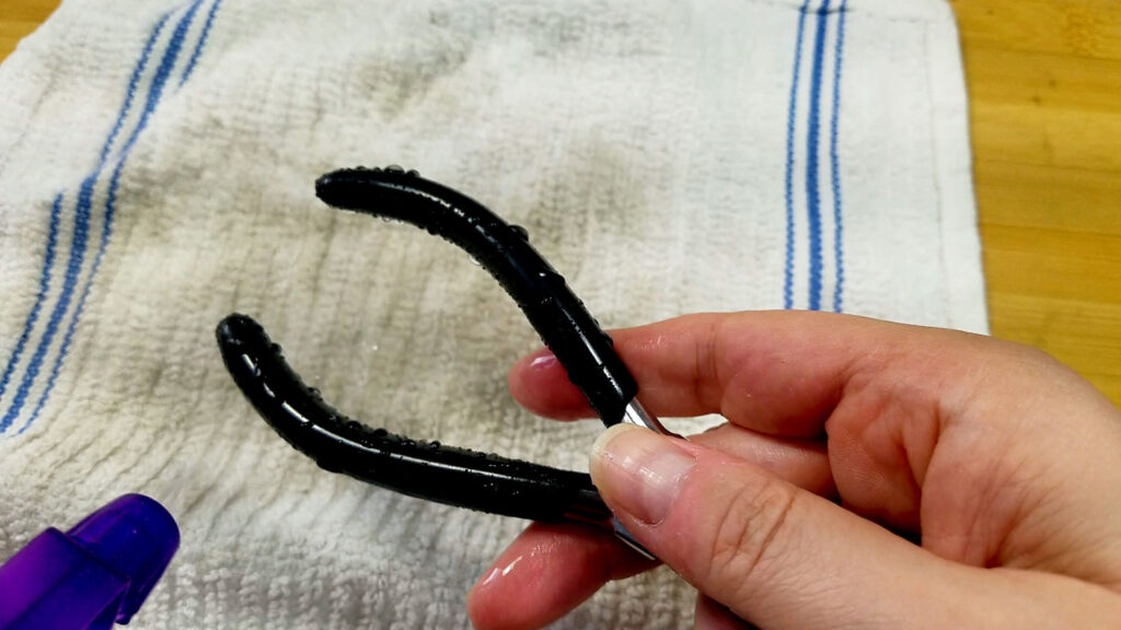 An image showing the author spraying the handles of her stepped bail-making pliers with water