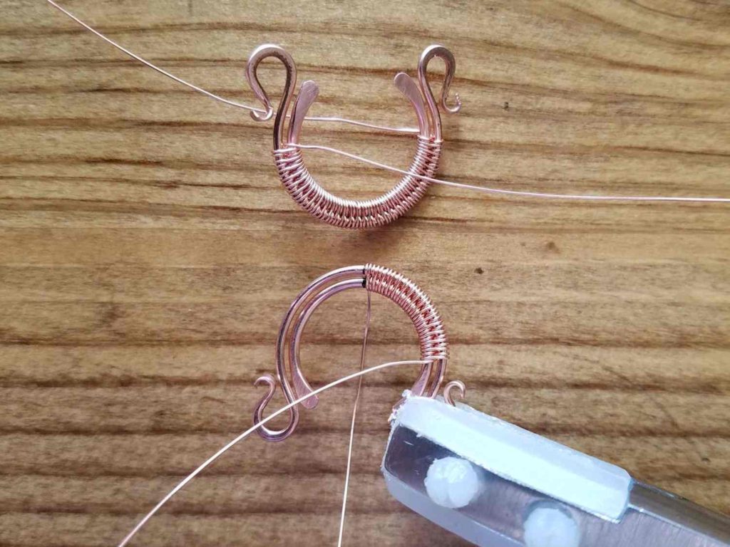 Step 2 - Starting at the center point of both your core wires and your weaving wire, use the modified soumak weave to weave your two core wires together, as shown. 