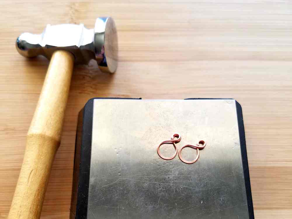 Step 13 - Work harden the wire tassel loops with a bench bloc and chasing hammer. Be careful to avoid marring the two 2mm simple loops.