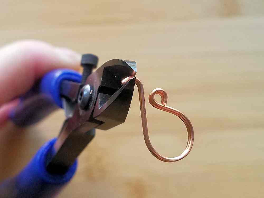 Use wire cutters to trim off the folded end of the wire. This will separate your two perfectly matched ear wires. 