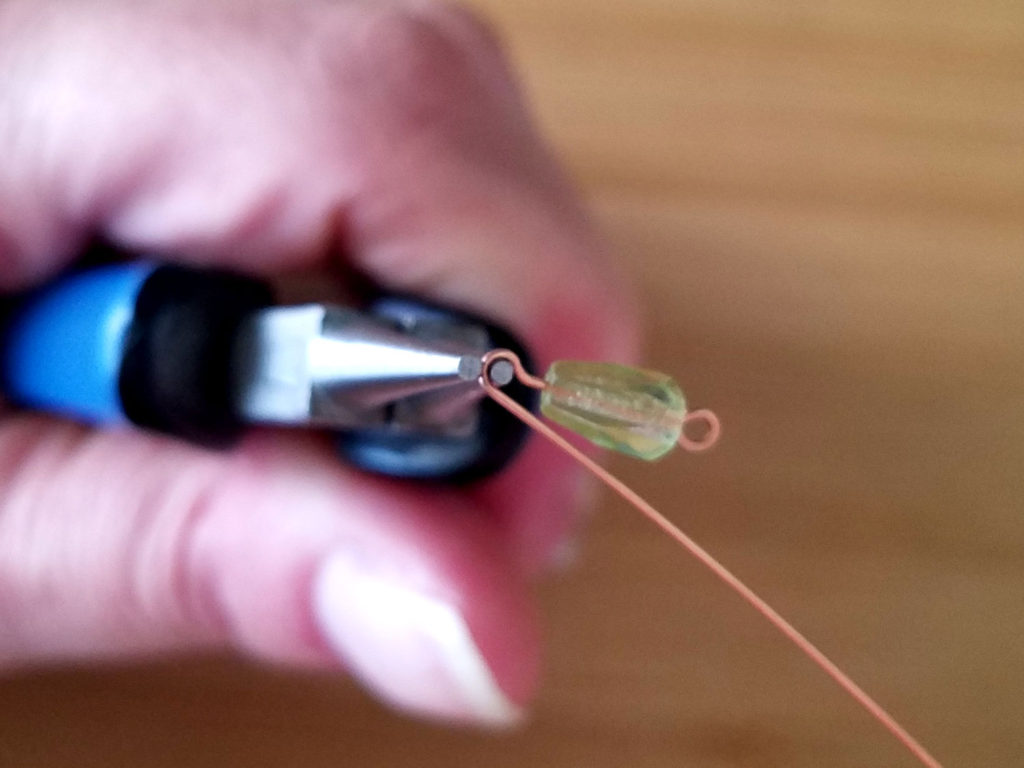 Step 5 - Reposition your pliers in order to continue forming the loop, as shown.