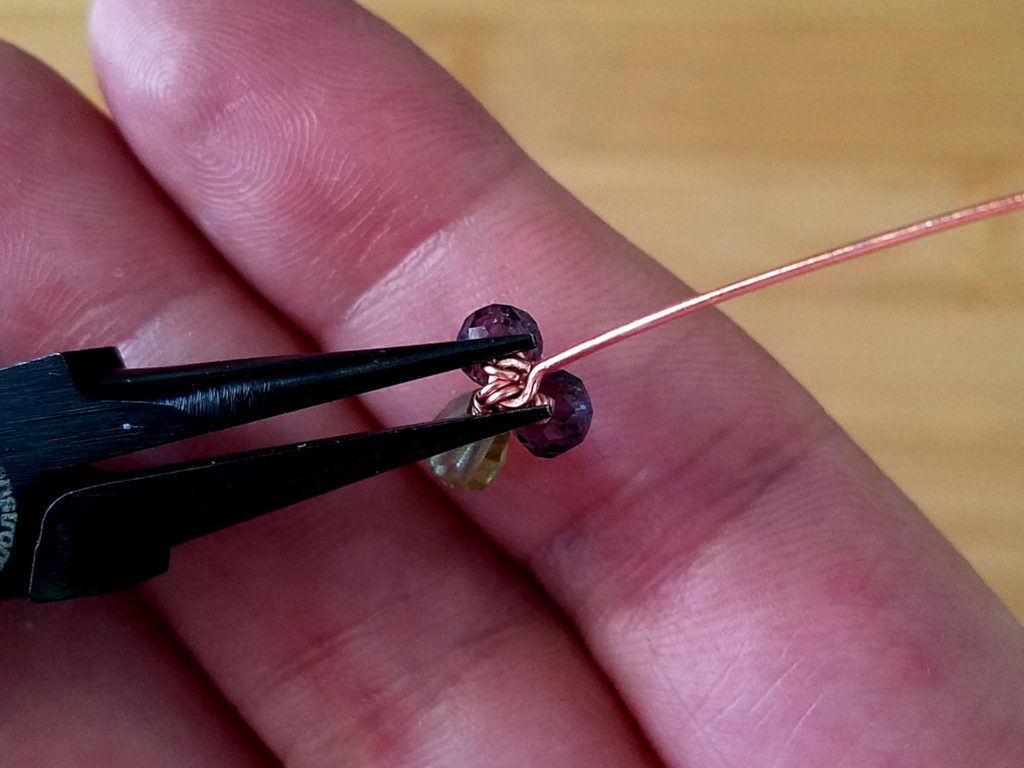 Step 5 - Squeeze the simple loop with your chain nose pliers to secure the beaded tassel, as shown.