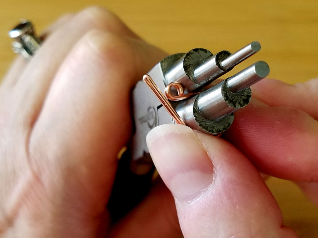 Step 8 - Roll the wire all the way around the 9mm step on your bail-making pliers, as shown. 