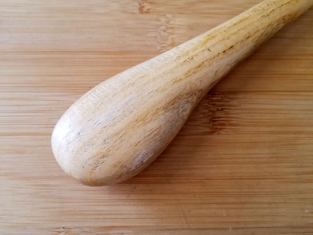 A closeup image of the bulbous end of a typical chasing hammer handle.