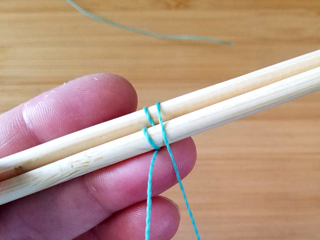 Step 5 - Bring the weaving wire down in front of both core wires, as shown.