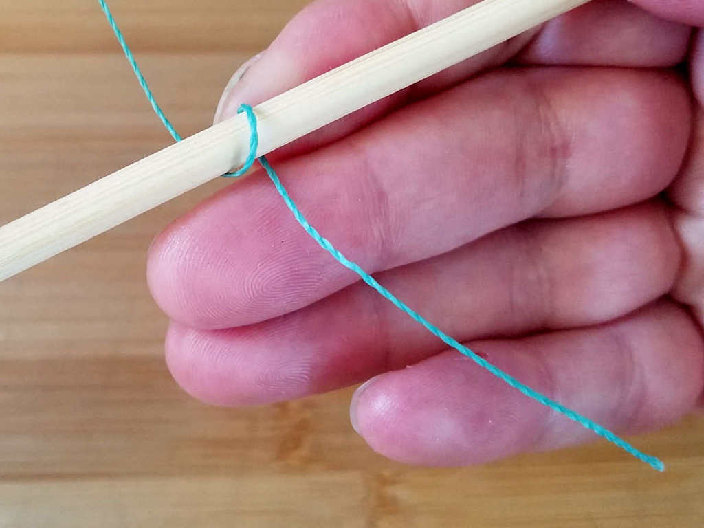 Step 2 - Wrap the weaving wire once around the first core wire, from front to back, as shown.