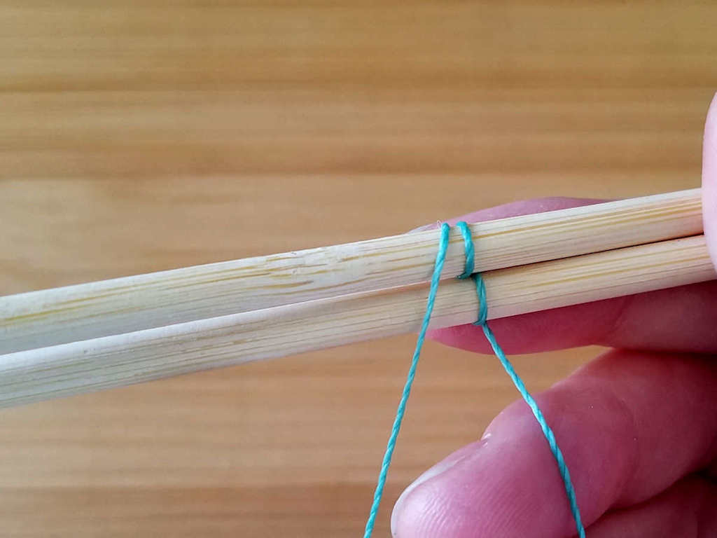 Step 5 - Bring the weaving wire down in front of both core wires, as shown. This completes the first pattern repeat of two single passes and one double pass.