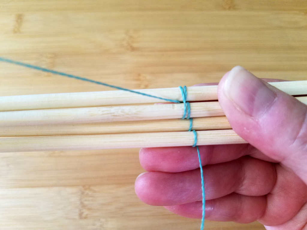 The first double wrap is completed by bringing the wire to the front between wires 3 and 4, as shown.