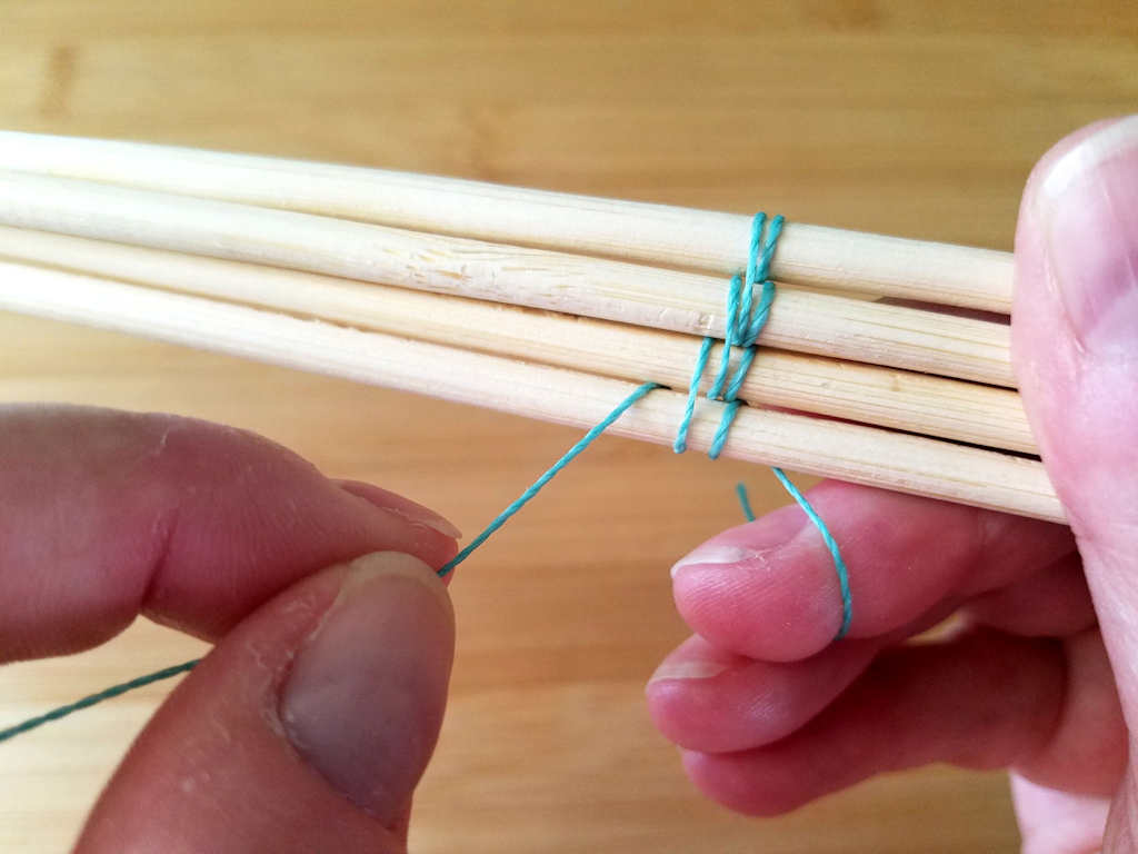 The final double wrap on the downward pass goes across wires 1 and 2 and then back to the front of the weave between wires 1 and 2, as shown.