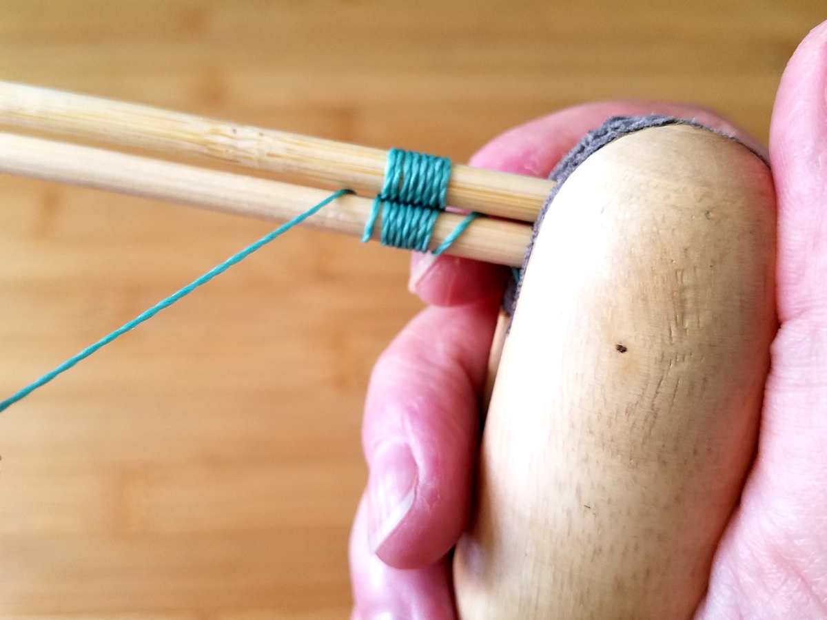 In this image, I've secured my core "wires" in my ring clamp, which I'm holding comfortably in my non-dominant hand while I weave. Using a ring clamp in this manner helps prevent hand fatigue. 