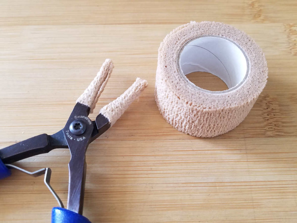 Pressure tape - the kind used for sports wraps - is another great tool for padding the jaws your jewelry pliers, as shown here.  This padding helps keep pliers from leaving marks on your wire. 