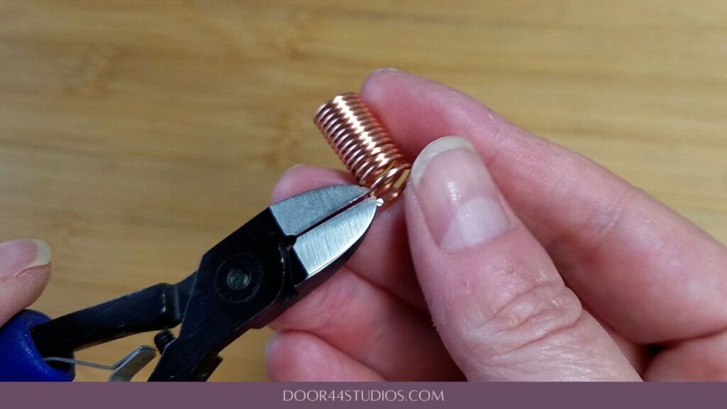 Aligning the surface of the pliers with the first flush cut before completing the second cut