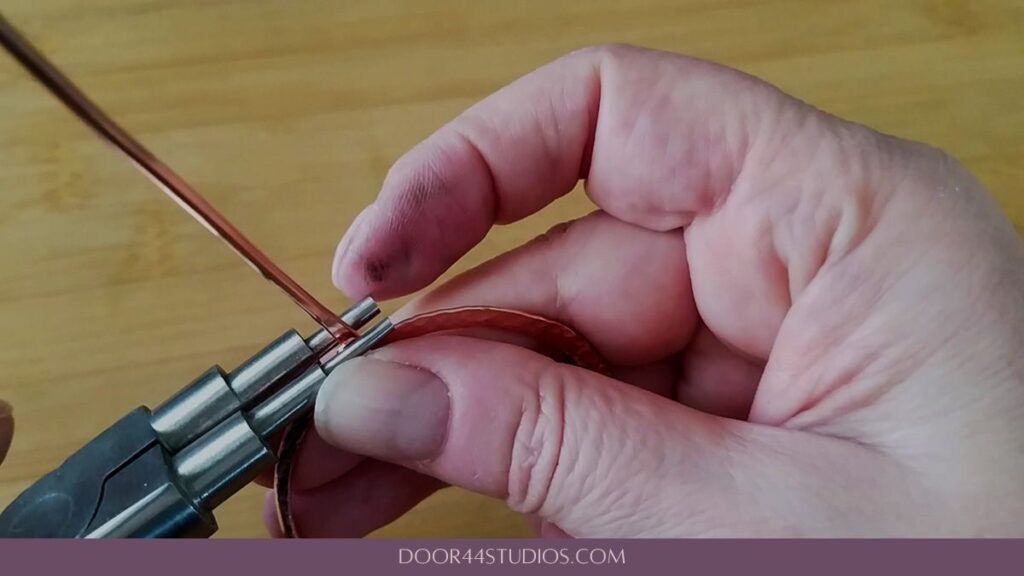 Securing the stick pin to the circlet by pressing the hook closed with stepped bail-making pliers