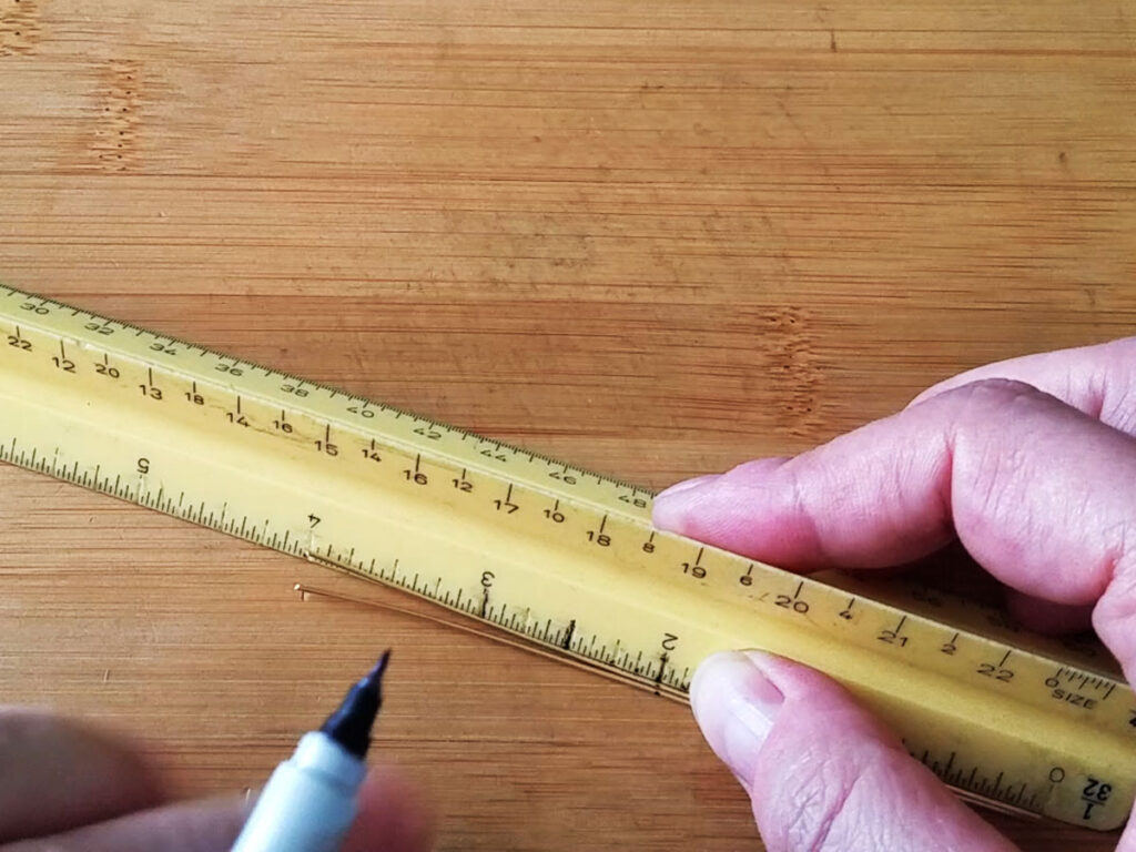 Measuring and marking two 4-inch lengths of wire at the center point, 2 inches