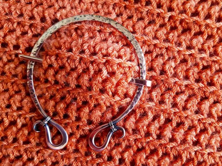 Quick, easy sweater pin - a simple hammered copper brooch worn on a crochet garment