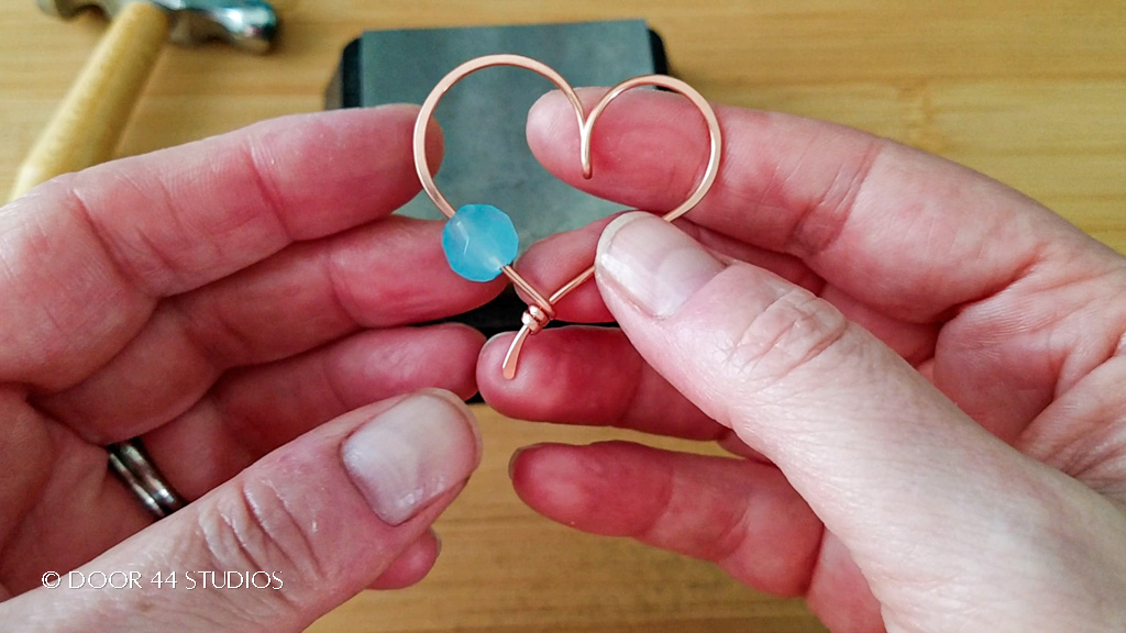 The quick and easy wire heart pendant is nearly complete now that the bead has been added to the frame