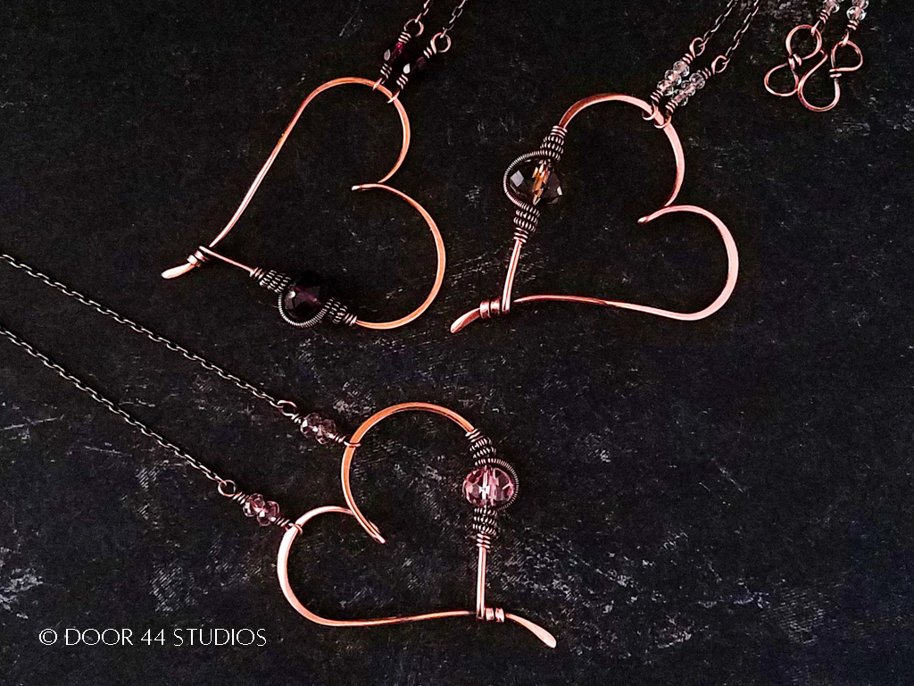 Three Quick and Easy Wire Heart Pendants in copper with pink, gray, and purple accent beads